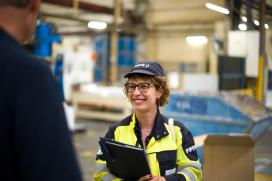 A close-up of female employee at Saint-Gobain  with a rewarding manufacturing career at Saint-Gobain North America on the plant floor.