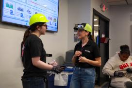 A Saint-Gobain employee works with a student during SFRC, a workforce development program