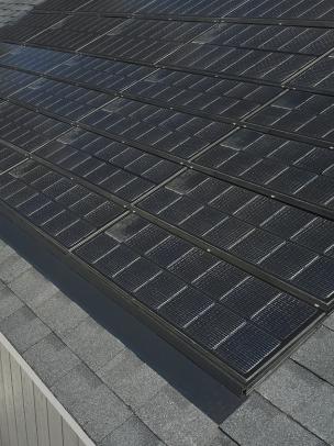 Sleek solar panels on a gray asphalt roof