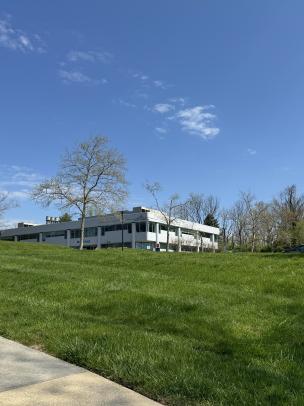 building on top of green grassy hill 